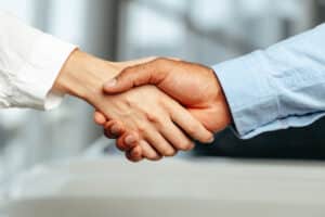 Female and male businesspeople handshake close up